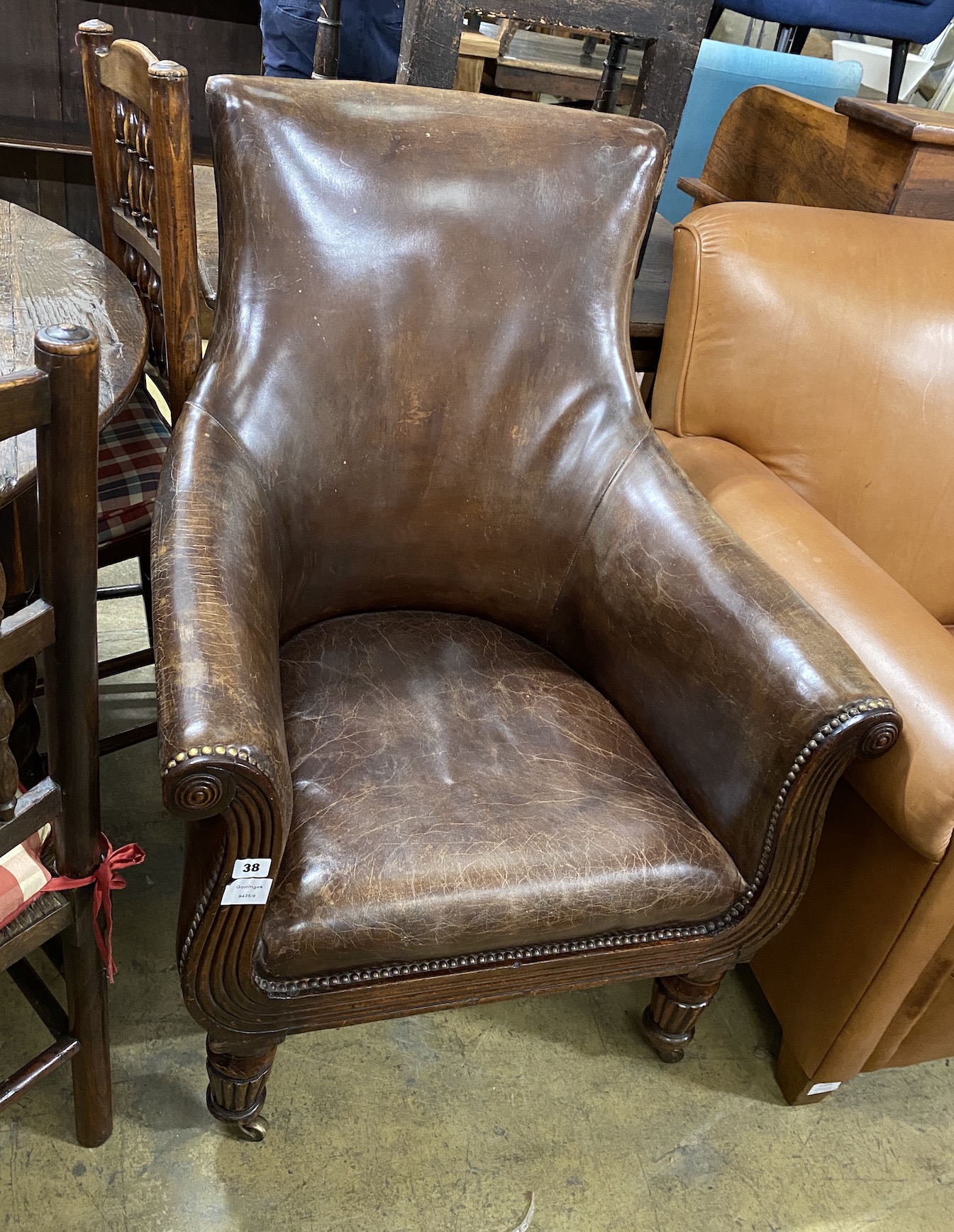 A Regency mahogany lyre framed tan leather library chair, width 71cm, depth 70cm, height 100cm